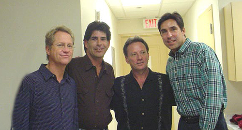 Gerry Beckley (America), Steve Knox, Dewey Bunnel, and Larry Knox posing for mug shots